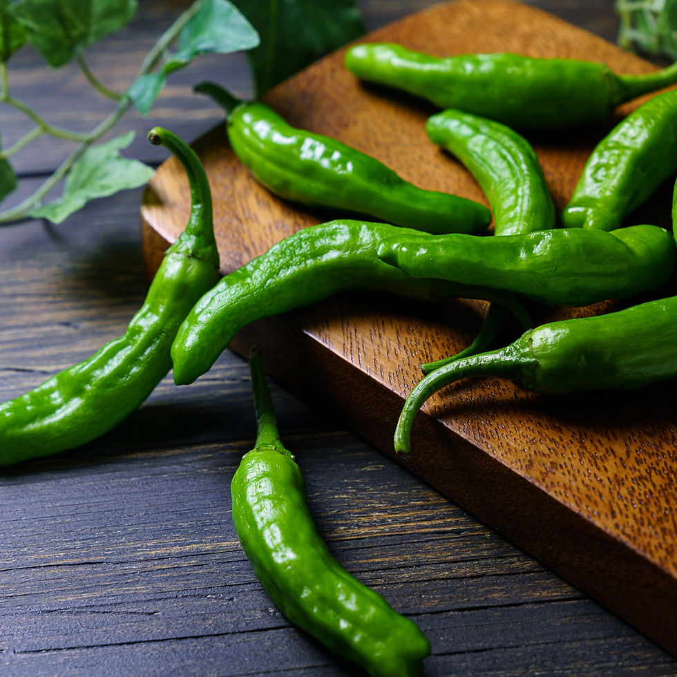 Shishito peppers on a cutting board.