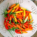 A colander filled with Tabasco chilis of various maturity.