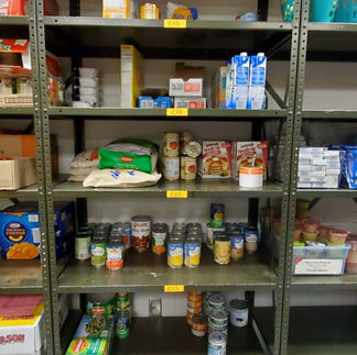 Pantry shelves show various canned food items on each of the 5 tiers