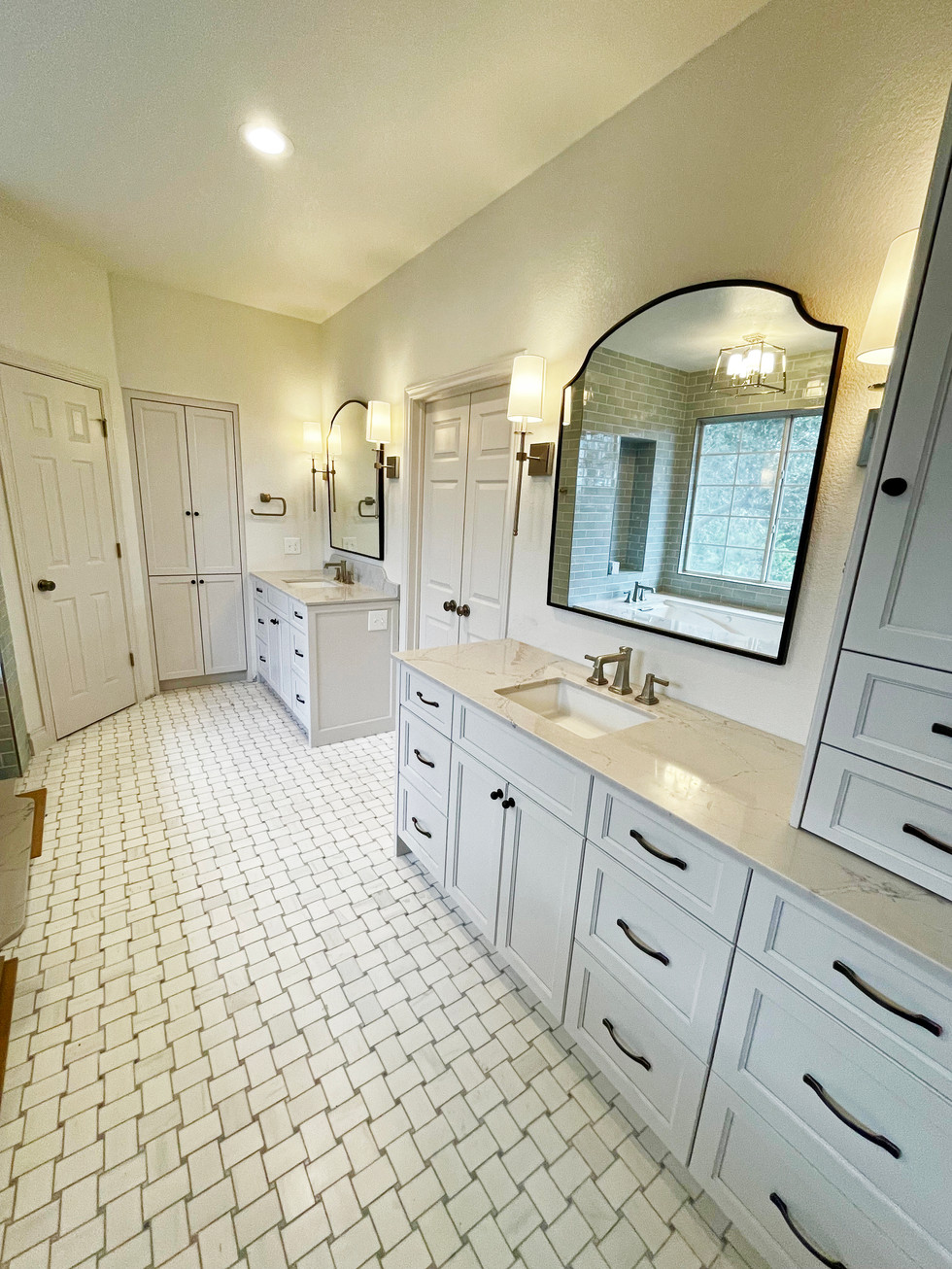 Custom Vanity Cabinetry. Marble Flooring, black accents.