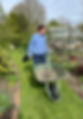 Lucy with a wheelbarrow in her garden