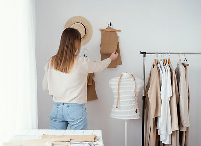 back-view-female-tailor-studio-with-clothes.jpeg