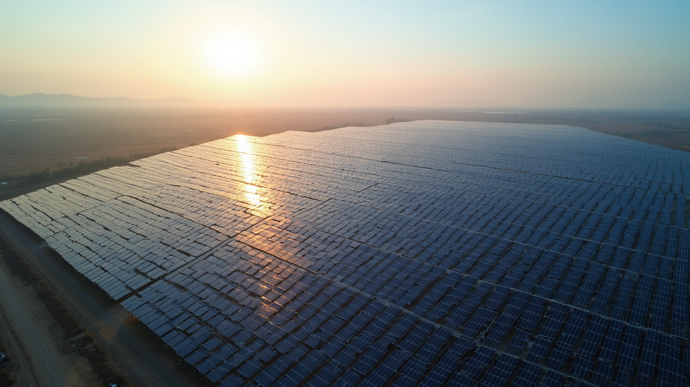 High angle view of a solar farm with rows of solar panels stretching into the distance