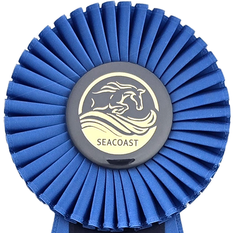 Blue award rosette with a foil-stamped center button featuring a horse logo and the word “Seacoast”
