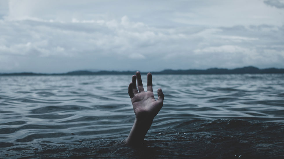 A hand reaches out from rippling dark water under a cloudy sky, conveying a sense of urgency and struggle.