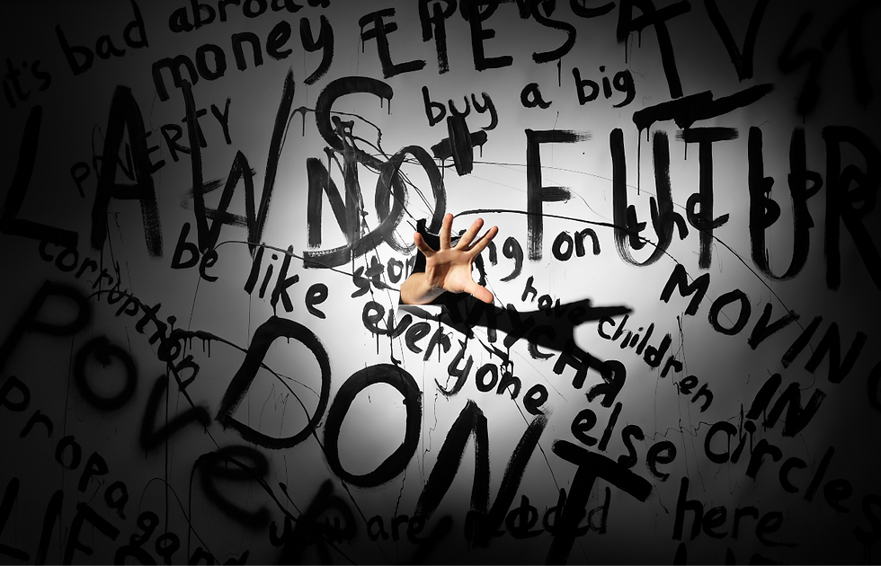 Hand reaches through a hole in a white wall covered in black graffiti words, with big NO and moody spotlight.