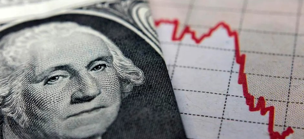 Folded US Dollar next a graph showing a decline in profits