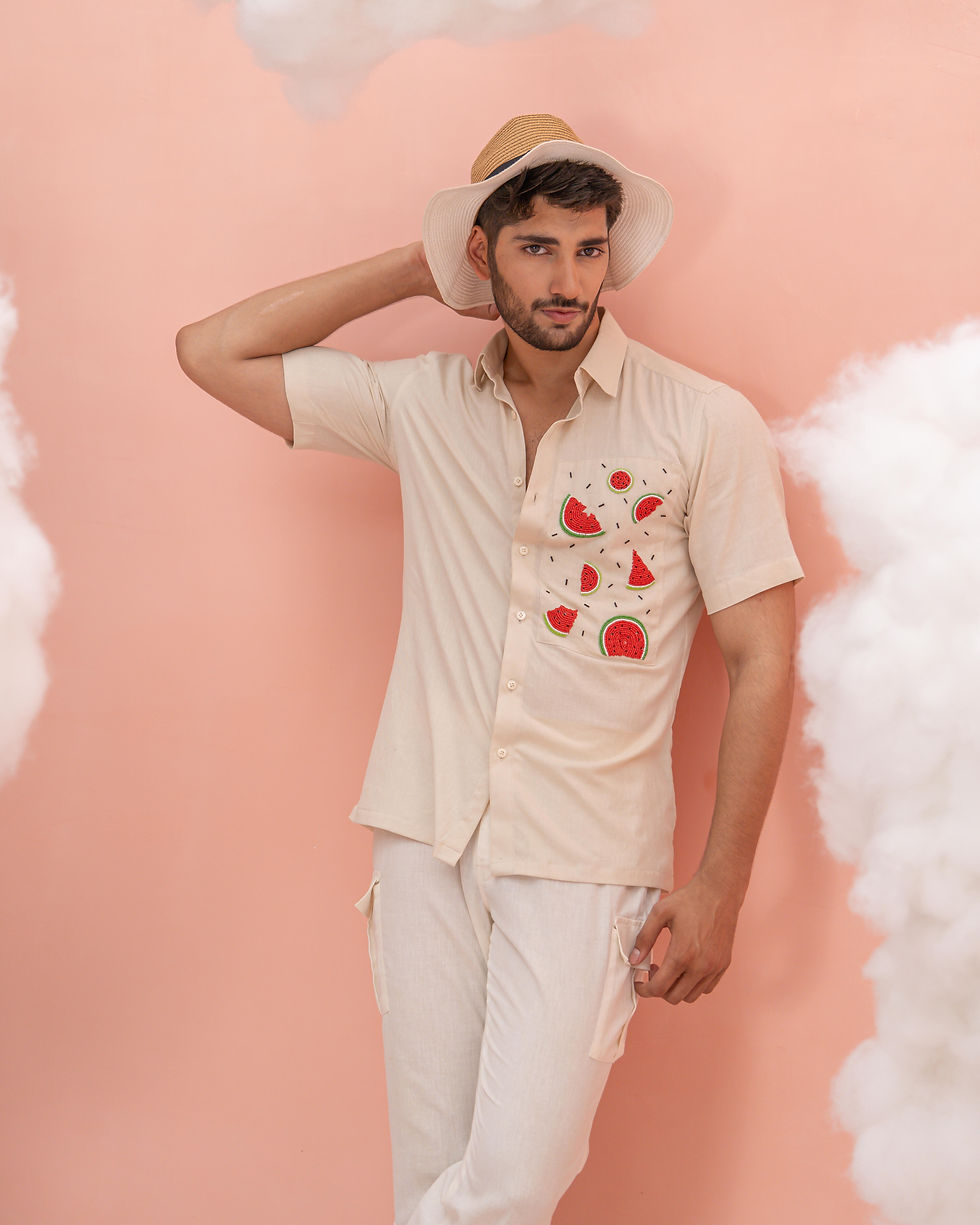 Thumbnail: Men’s Watermelon Shirt by Runit Gupta with intricate watermelon motif embroidery on a beige short-sleeve shirt, blending play