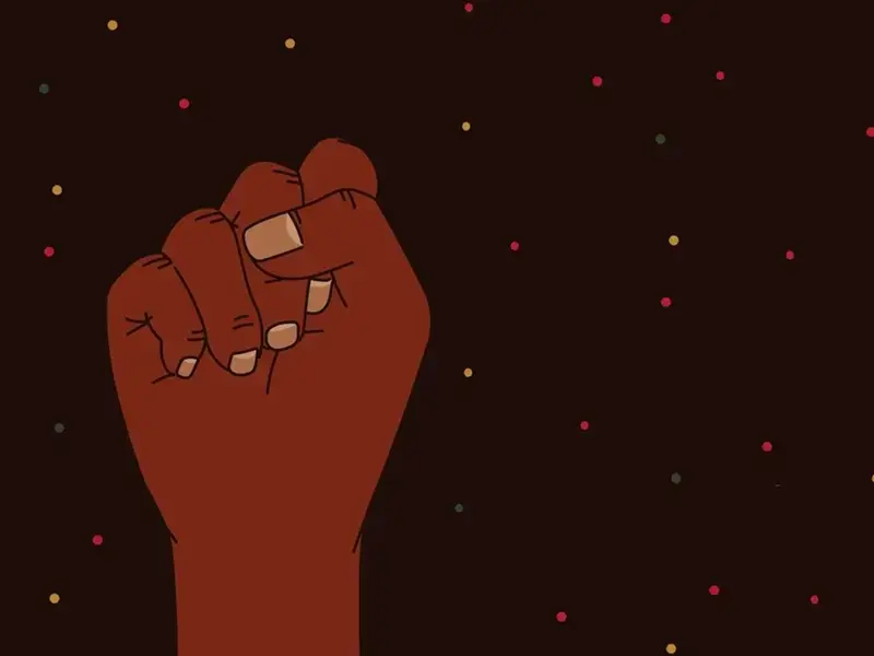The hand of a black person raised and making a fist
