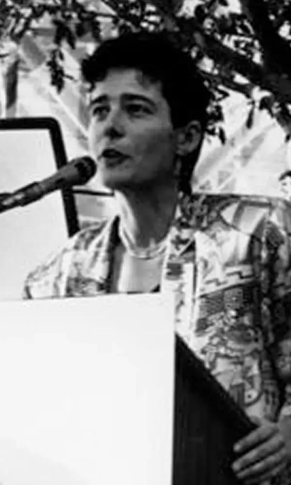Photo of Betty Baxter speaking into a microphone at a podium