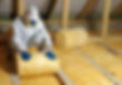 Construction worker thermally insulating house attic with glass wool .jpg