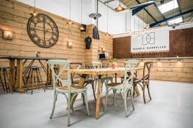 Double Barrelled brewery, empty with a big clock on the wall, logo and tables & chairs