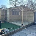 Bespoke timber garden bar building with decking and verandah, made to fit a customer's garden in Cheshire