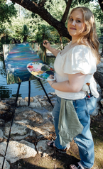 Allison Owens, live event artist, Editor of Romantasy Illustrated, painting at the pond of Hidden Gardens Venue