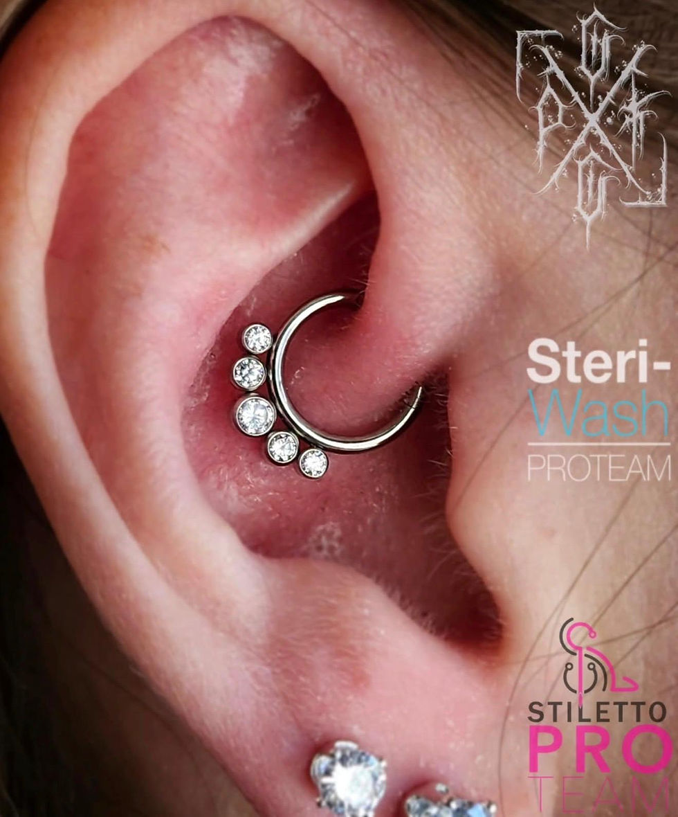 Daith piercing with silver gemstone cluster jewelry installed by a professional body piercer in Winn