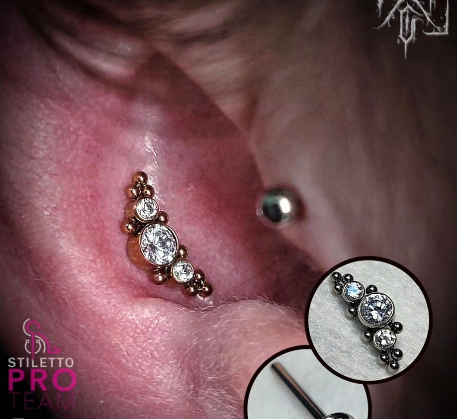 Inner ear cartilage piercing with implant-grade gemstone jewelry performed by a professional piercer in Winnipeg