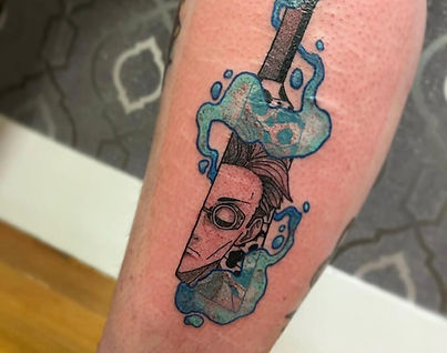 Anime style tattoo of character inside a sword with blue water effects and fine line detail by Mad Bowen Tattoos