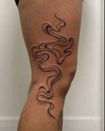 Abstract smoke tattoo with black linework and negative space wrapping around the thigh by Crista Liana.