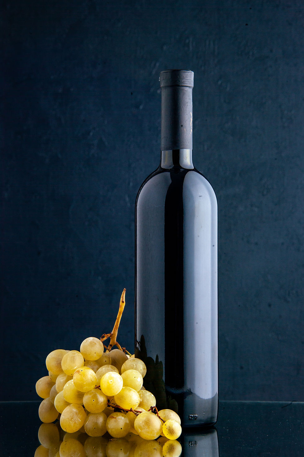front-view-bottle-wine-with-fresh-grapes-dark-background-fruit-drink-alcohol-color-photo.j