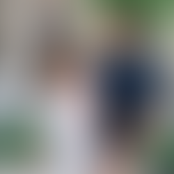 Bride and groom smiling at each other holding hands