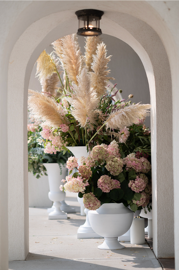 Floral arrangements sitting in an archway