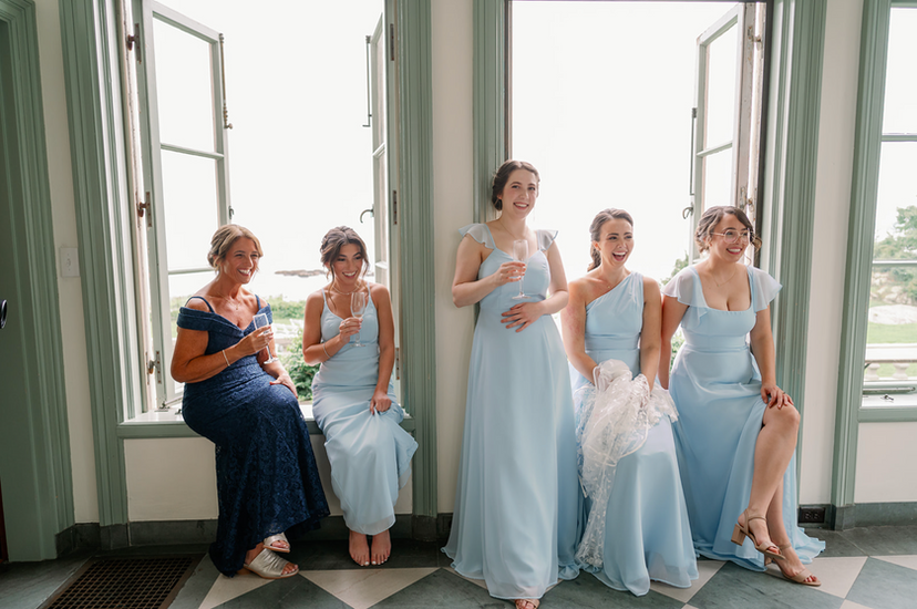 Bridesmaids watching the bride get ready.