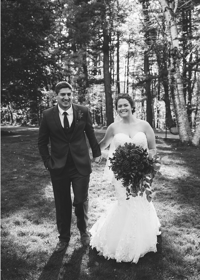 Bride and groom holding hands and smiling