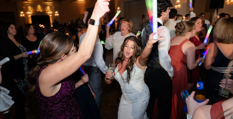 A bride and her wedding guests dancing.