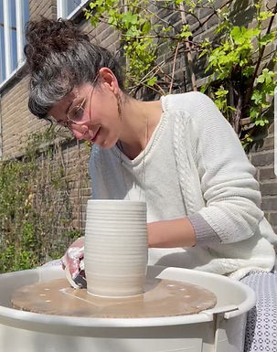 Ella Gutman in action throwing Porclain handcrafted ceramic vase on a pottery wheel