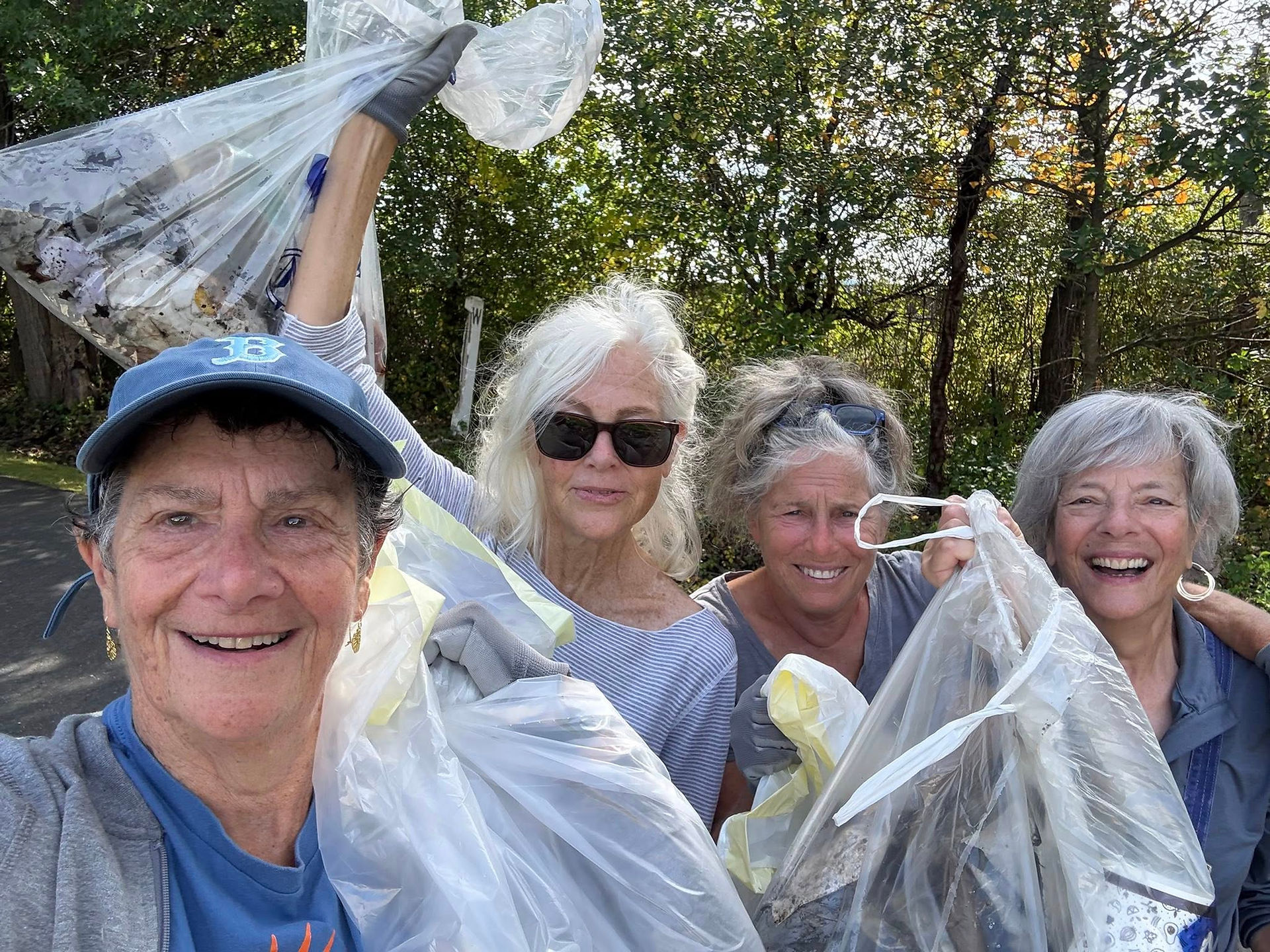 Volunteers pose with collected trash