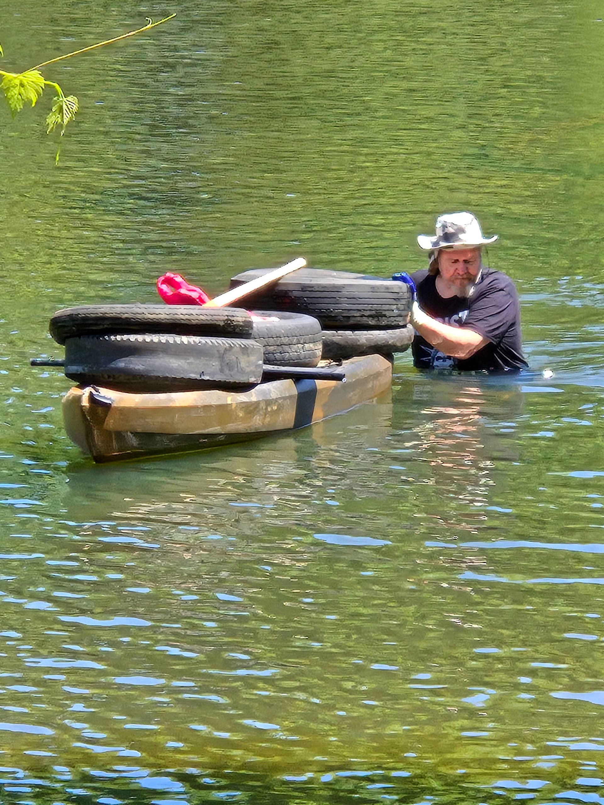 Volunteers pose with trash they collected from the river