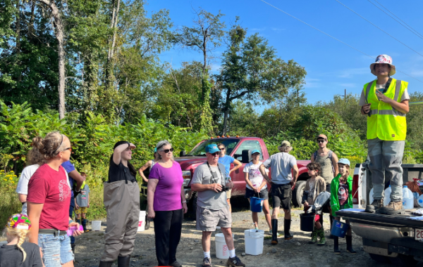 volunteers standing in a circle getting instructions
