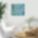 Abstract blue and gold painting on wall above white chair in living room