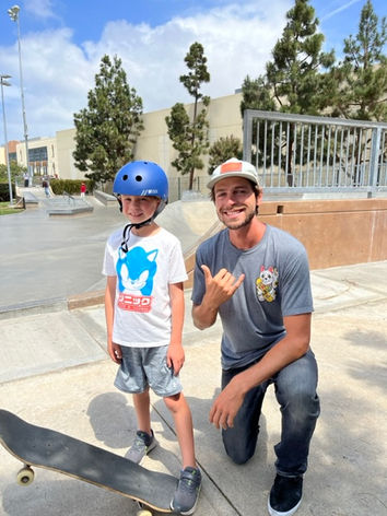 skate coach and a kid learning to skateboard