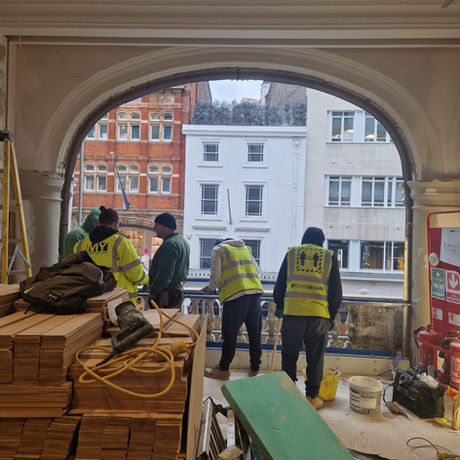 On-site installation of a large arched window with scaffolding during the Halcyon Gallery refurbishment.