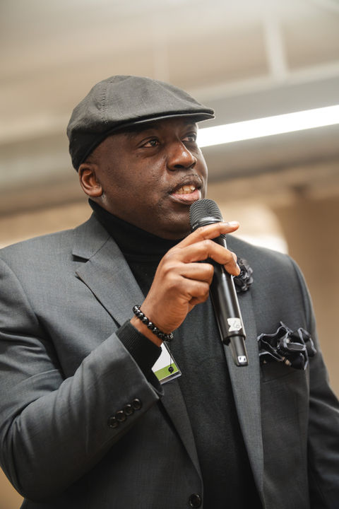 Man asking a question into a mic at a conference during a Q&A