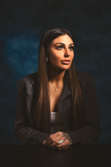 Dark and moody atlanta studio lawyer portrait against a blue muslin background