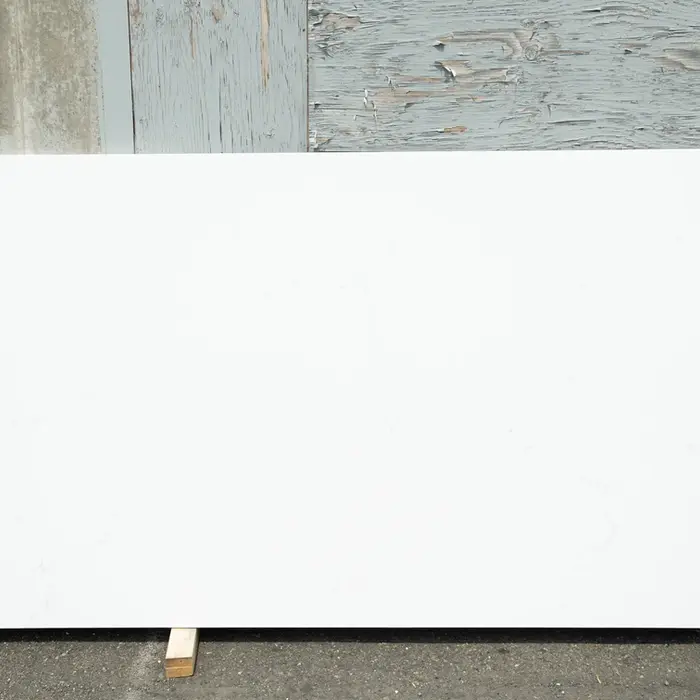 Large white countertop against a weathered wall, a blank canvas.