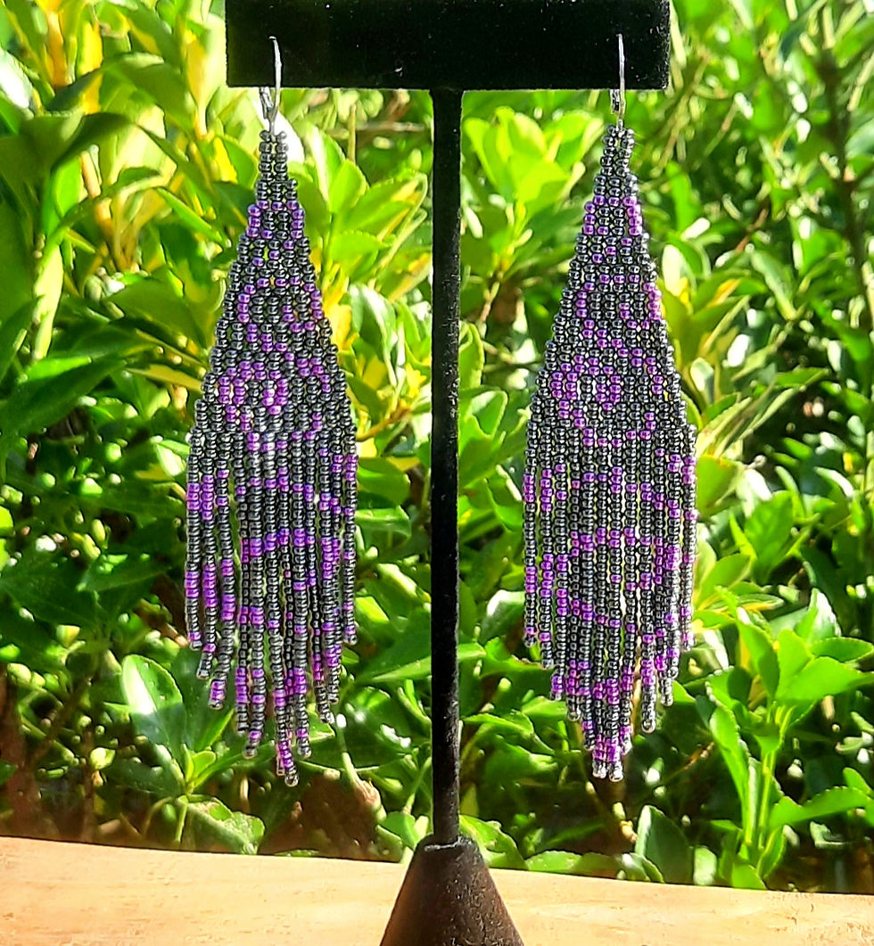 Thumbnail: Handmade gunmetal and purple seed bead fringe earrings hanging on a display