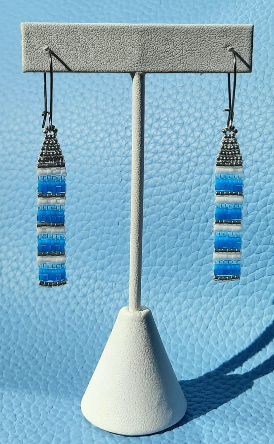 Thumbnail: handstitched seed bead earrings (silver, white, 3 shades of blue); stainless steel ear hooks.