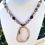 Thumbnail: Handmade necklace w/ Bronzite, Amber Fire Crackle Agate, glass beads; 2.5" sliced Agate Quartz pendant; gold toggle clasp.