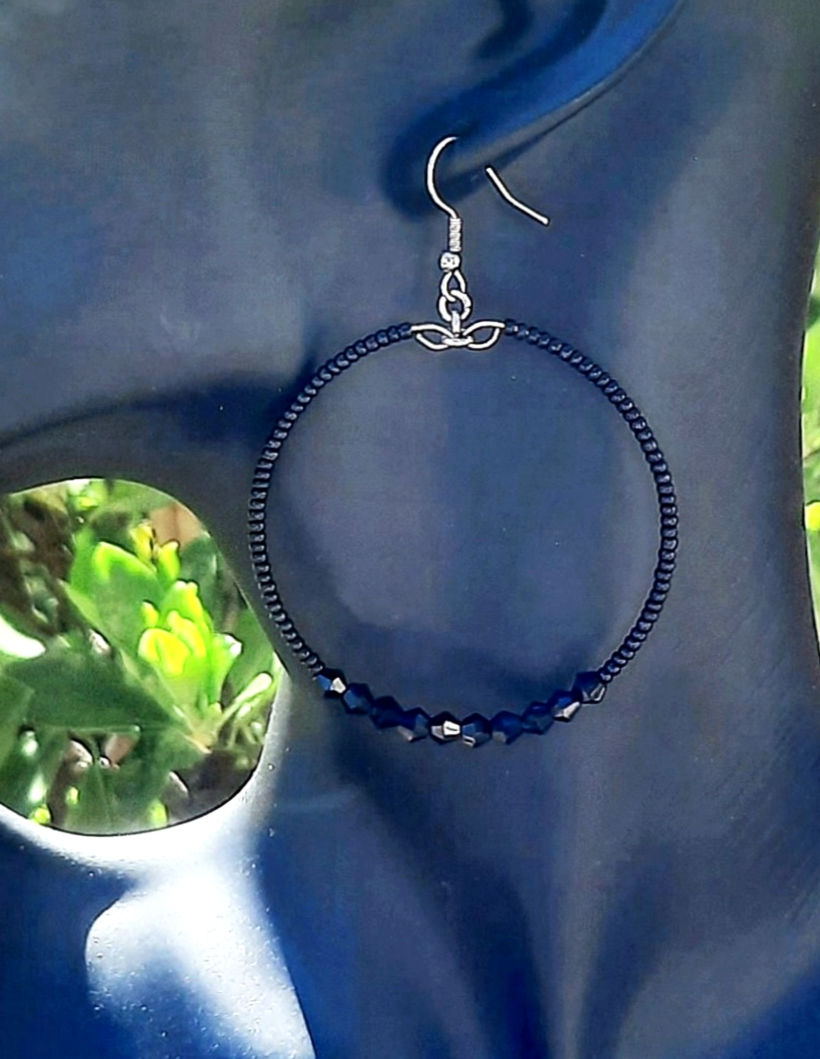 Black seed bead hoop earring with black crystals and stainless steel ear hooks.