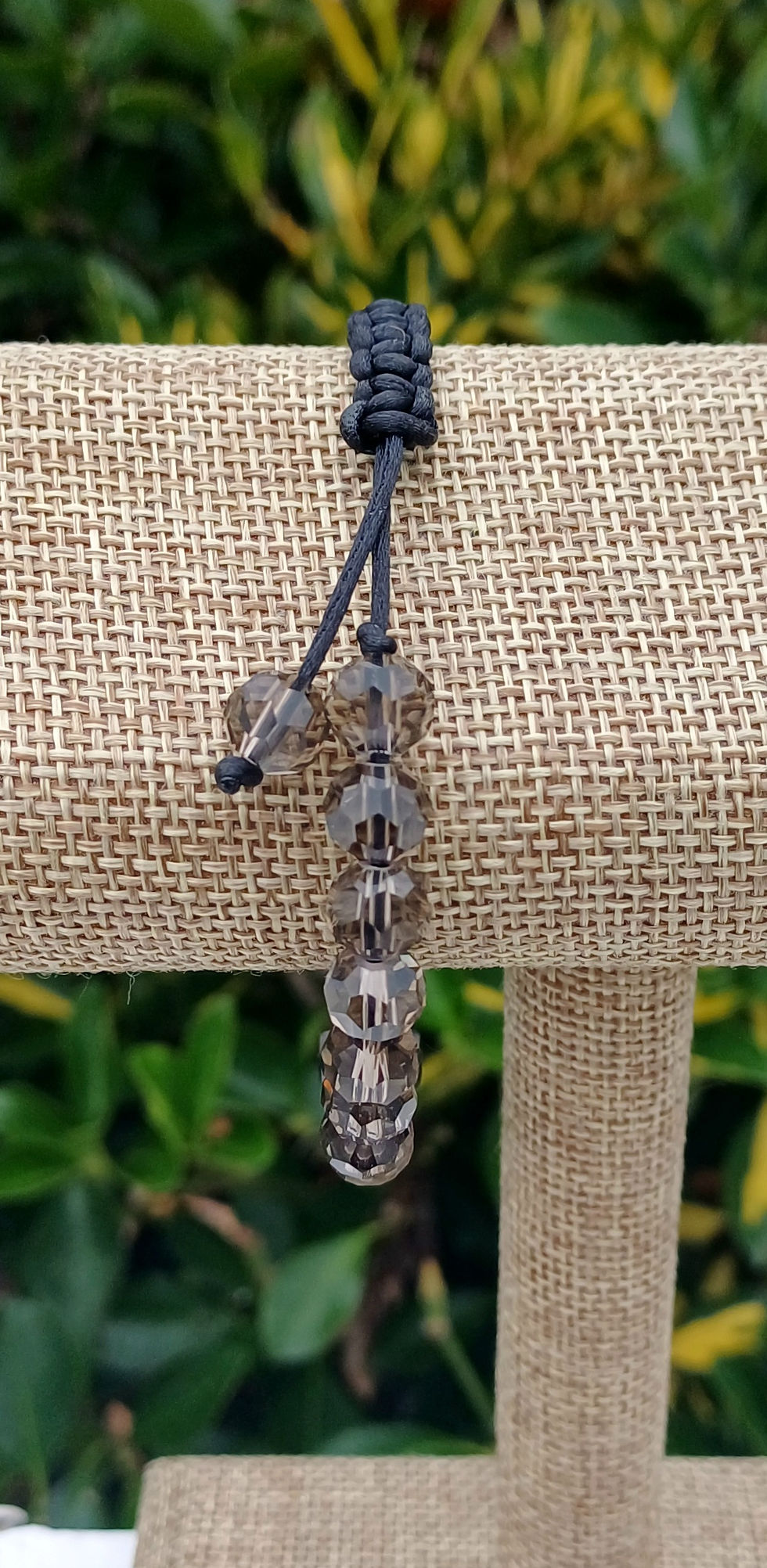 Thumbnail: Smoky quartz crystal beaded bracelet with an adjustable sliding knot closure on a black satin cord