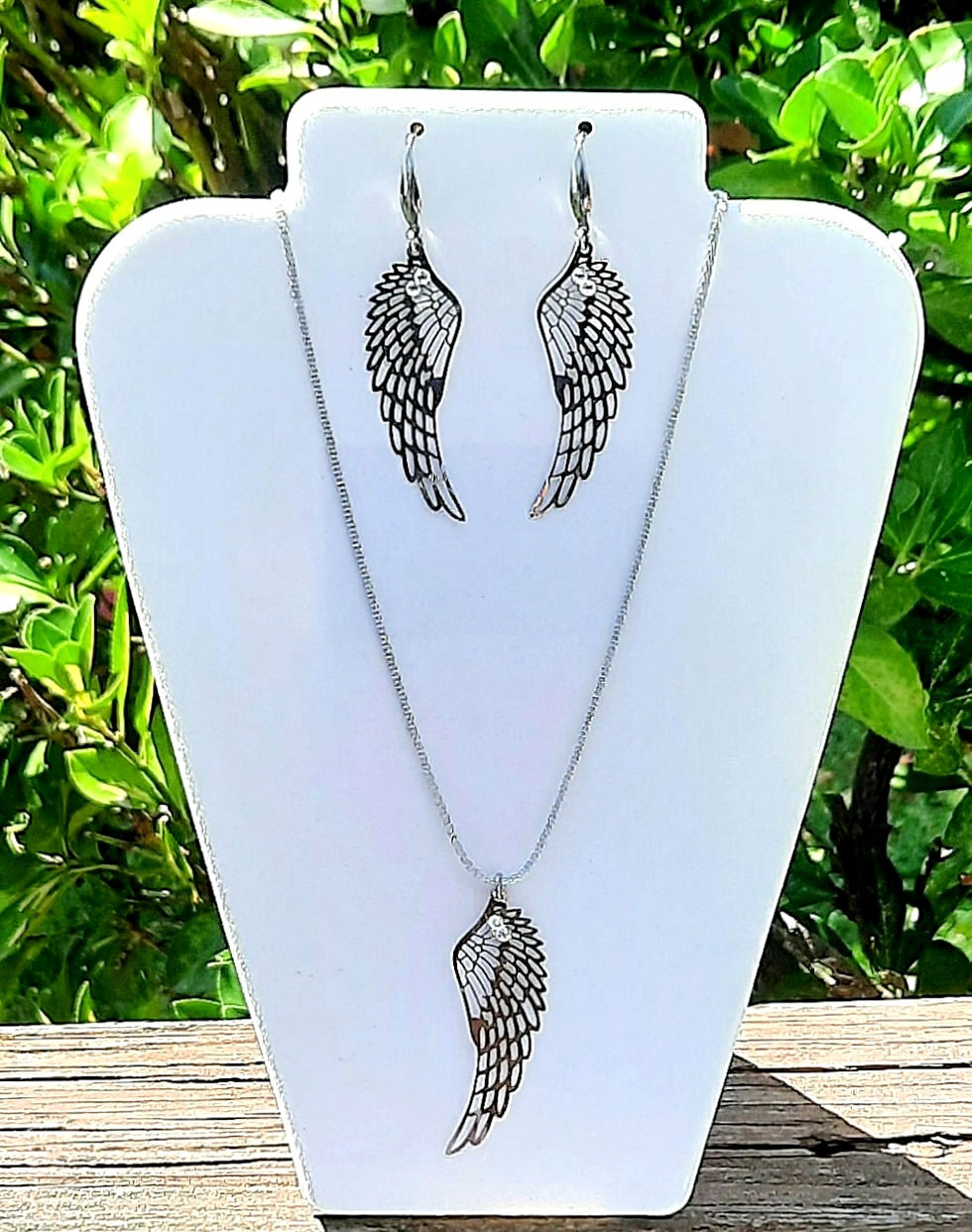 Thumbnail: stainless steel laser cut angel wing earrings/pendant with clear flatback crystals.