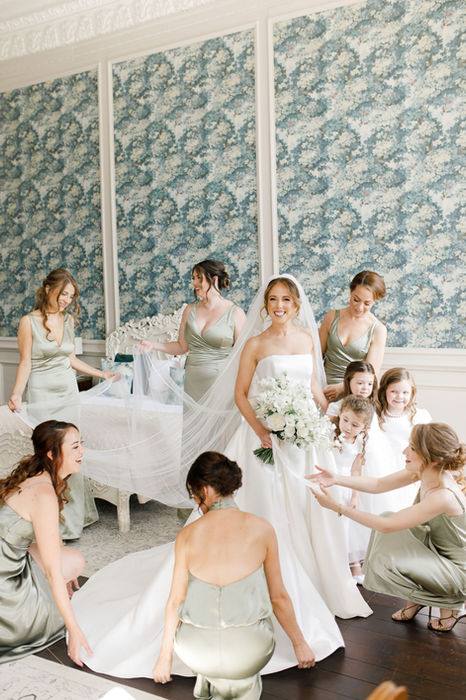 Bride with bridesmaids and flower girls in a bridal suite