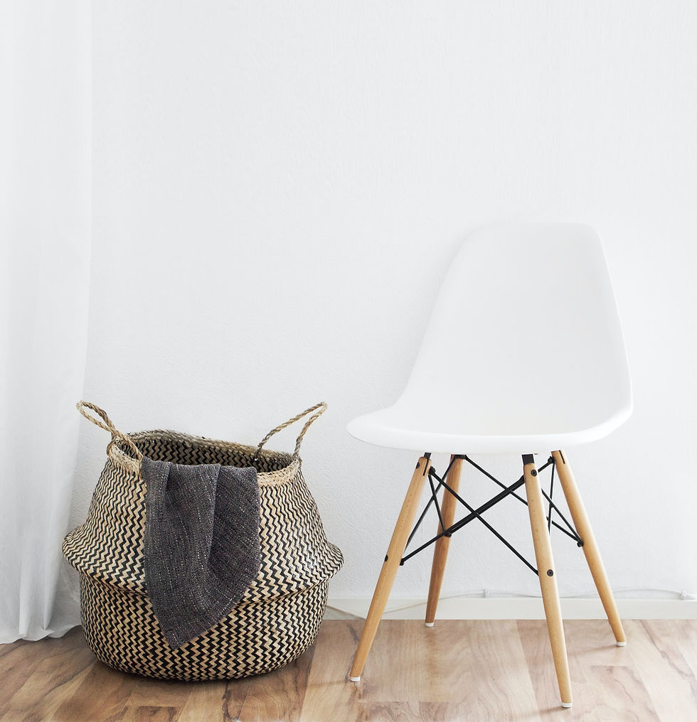 A white chair with a laundry basket