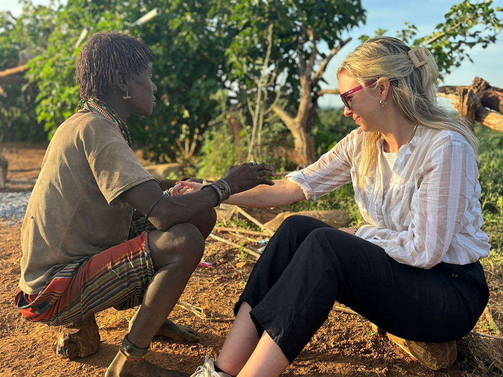 Monica getting her fortune told (using butter on her arm) by our friend and partner Melke