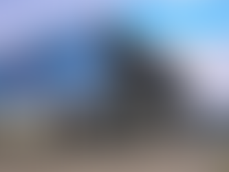 Modular bacterial VOC removal system installed at a refinery site, featuring a skid-mounted biofiltration unit housed under a blue metal shed with integrated piping, scaffolding, and industrial gas treatment equipment.