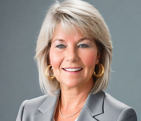 Headshot of smiling businesswoman in gray suit