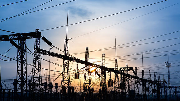 distribution electric substation with power lines and transformers, at sunset horizontal f